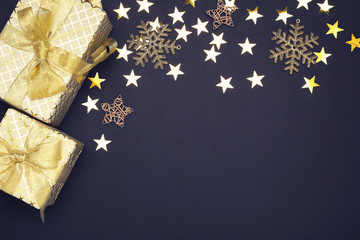 Gift boxes with stars and snowflakes on black background