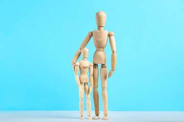 Wooden family figures on blue background