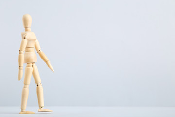 Wooden figure on grey background