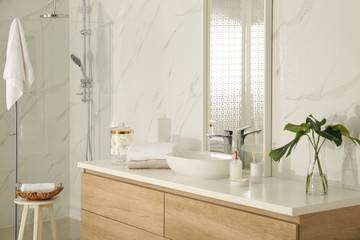 Large mirror and vessel sink in stylish bathroom