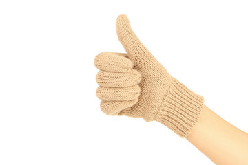 Hand in knitted mitten showing thumb up on white background