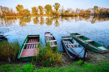 Old boat on the autumn pond