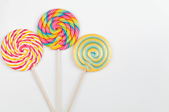 rainbow color lollipops on white background