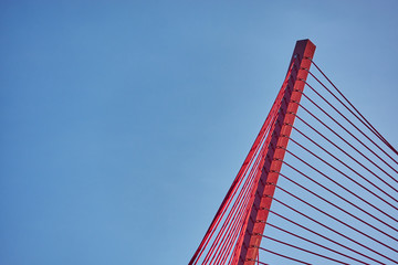 Abstract architectural features, steel beam with cables on sky background