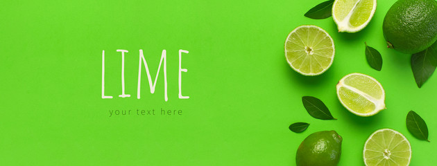 Fresh juicy lime and green leaves on bright green background. Top view flat lay copy space. Creative food background, tropical fruit, vitamin C, citrus. Composition with whole and slices of lime