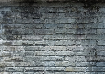 Background. The textured surface of the outer wall of grey stone