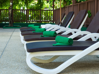 Folded towels on sun loungers by the pool at the hotel. Selective focus