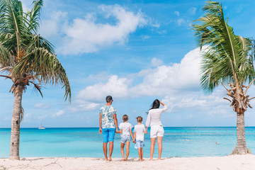 Happy beautiful family with kids on the beach