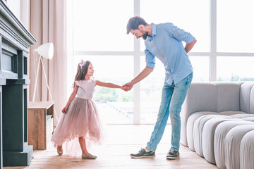 happy girl and father having fun together at home