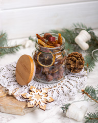 Different fruit leather, dried banana, kiwi, orange slices in the glass jar.