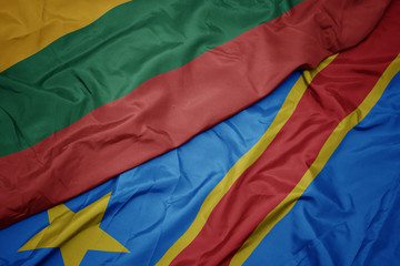 waving colorful flag of democratic republic of the congo and national flag of lithuania.