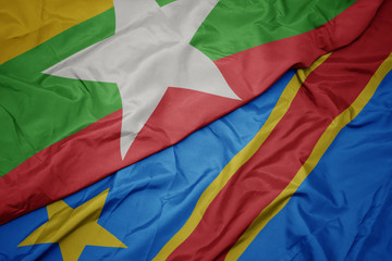 waving colorful flag of democratic republic of the congo and national flag of myanmar.