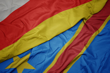 waving colorful flag of democratic republic of the congo and national flag of south ossetia.