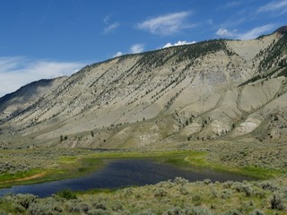 Dramatic hills and lush valleys, with the Yellowstone River flowing along at Yellowstone National Park.
