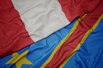 waving colorful flag of democratic republic of the congo and national flag of peru.