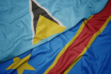 waving colorful flag of democratic republic of the congo and national flag of saint lucia.