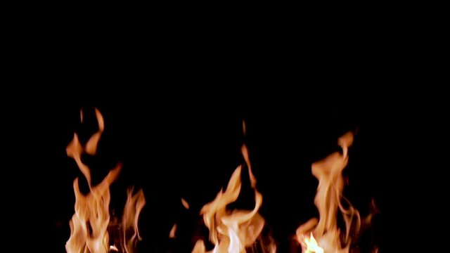 Slow motion video of real fire burning on a black background. Captured in 96 fps. Useful for video-integration, special effects or as a moving motion background. 