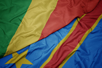 waving colorful flag of democratic republic of the congo and national flag of republic of the congo.