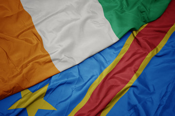 waving colorful flag of democratic republic of the congo and national flag of cote divoire.