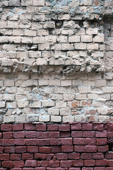 Old destroyed red brick wall as background vertical view closeup