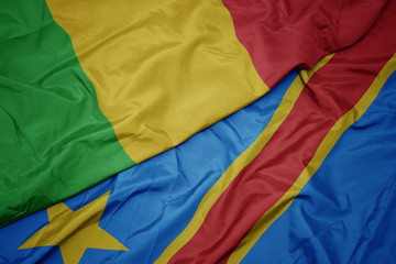 waving colorful flag of democratic republic of the congo and national flag of mali.