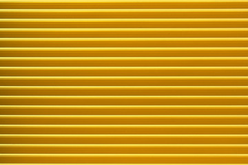 Closed yellow roller shutter texture for background