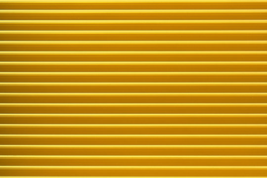Closed yellow roller shutter texture for background