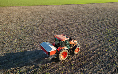 Tractor spreading artificial fertilizers