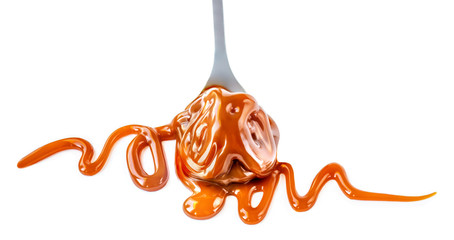Caramel candie and flowing caramel sauce on a spoon  isolated on  white background