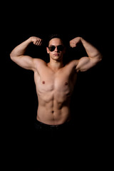 Fototapeta na wymiar muscular guy on a black background. studio photo