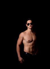 muscular guy on a black background. studio photo