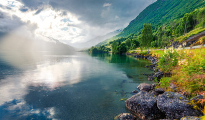 Dramatic summer view of Lovatnet lake, municipality of Stryn, Sogn og Fjordane county, Norway. Colorful rainy scene in Norway. Beauty of nature concept background.