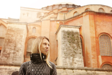 Fototapeta na wymiar Explore Turkey, Visit Istanbul concept. Woman Tourist near Hagia Sophia portrait