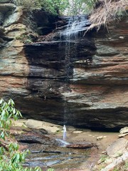 Standing behind a waterfall.