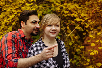 Loving couple in plaid shirts.