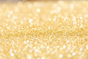 Defocused gold glitter background. Gold abstract bokeh background. Christmas abstract background.