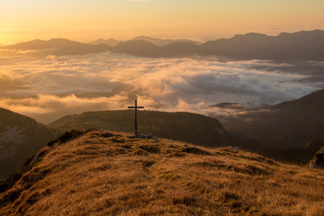 Fototapeta na wymiar Sunlit grass with cross on top of a mountain, Bohinj
