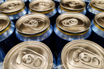 Top view on closed metal tin cans with pull ring. Tin cans with beer. Close-up