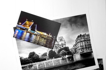 Photography canvas prints on white wooden background. Travel photos printed on glossy synthetic canvas