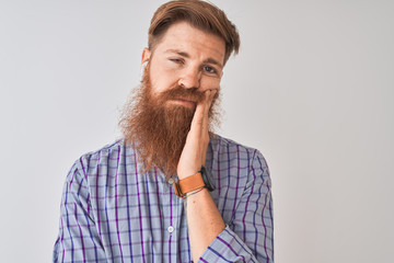Redhead irish man listening to music using wireless earphones over isolated white background thinking looking tired and bored with depression problems with crossed arms.