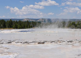 Wide shot of the fountain Paint Pot at Lower Geyser Basin, with clear skies at Yellowstone National Park, Wyoming.
