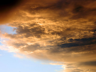 Naklejka na ściany i meble A veil of gray thunderclouds obscures the blue sky