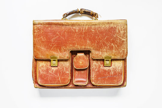 Old leather briefcase in white background
