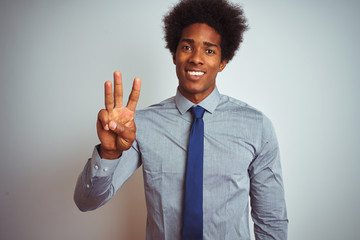American business man with afro hair wearing shirt and tie over isolated white background showing and pointing up with fingers number three while smiling confident and happy.