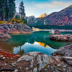 Great autumn view of Fusine lake. Colorful morning scene of Julian Alps with Mangart peak on...