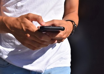 Male hands using a mobile pone
