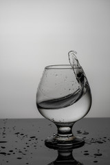 splash of water in a glass with drops on glass