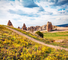 Bright spring scene of Cappadocia. Stunning morning view of of Red Rose valley in April. Cavusin village located, district of Nevsehir, Turkey, Asia. Traveling concept background.