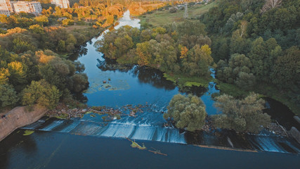 Evening river dam at the forest, Ukraine