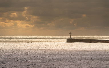 Fototapeta premium Entrance to Sevastopol Bay between lighthouses in the setting sun